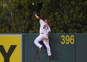Angels' Mike Trout makes leaping catch on a ball hit by Mariners' Jesus Montero. (AP Photo/Mark J. Terrill)