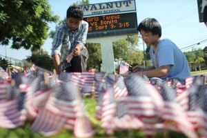 Students place 9/11 flags in front of Walnut High School on Thursday.