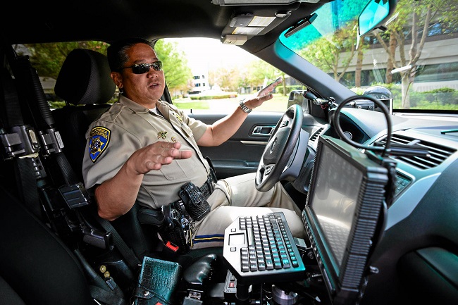 CHP officer Leland Tang shows how the CHP uses heads up technology to help officers keep their eyes on the road at all times. 
