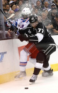 Rangers Marc Stall is checked into the boards by Kings Jeff Carter in the 3rd period of a Stanley Cup Final game. Carter had a hat trick in the Kings exhibition game Sunday. (Photo by John McCoy / Los Angeles Daily News)
