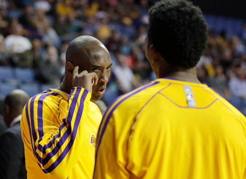 Los Angeles Lakers' Kobe Bryant, left, talks to Nick Young before an NBA preseason basketball game against the Denver Nuggets on Tuesday, Oct. 8, 2013, in Ontario, Calif. (AP Photo/Jae C. Hong)