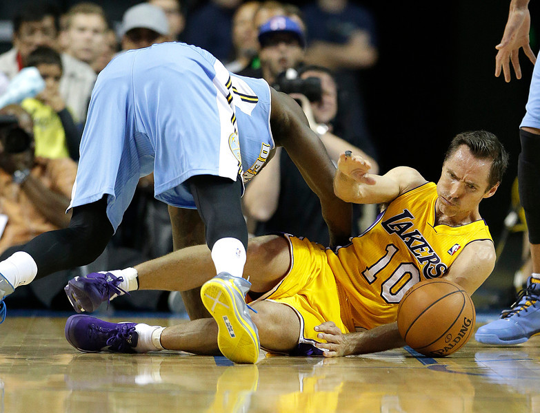 Denver Nuggets' Randy Foye, top, and Los Angeles Lakers' Steve Nash fall to the court as they fight for a loose ball in the second half of an NBA preseason basketball game on Tuesday, Oct. 8, 2013, in Ontario, Calif. The Lakers won 90-88. (AP Photo/Jae C. Hong)