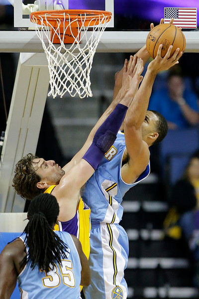 Denver Nuggets' JaVale McGee, right, tries for a shot against Los Angeles Lakers' Pau Gasol, of Spain, in the first half of an NBA preseason basketball game Tuesday, Oct. 8, 2013, in Ontario, Calif. (AP Photo/Jae C. Hong)