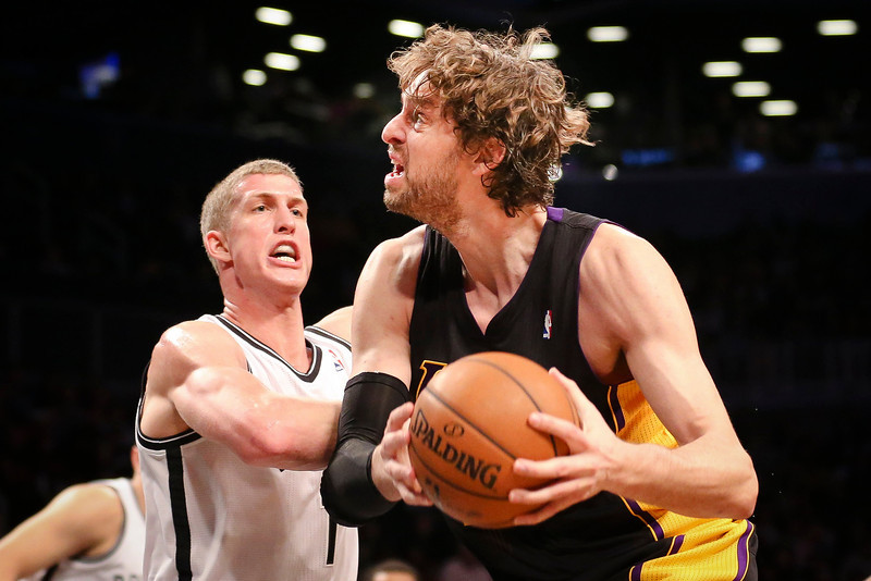 Los Angeles Lakers center Pau Gasol, right, drives to the basket against Brooklyn Nets power forward Mason Plumlee (1) in the fourth quarter of an NBA basketball game at the Barclays Center, Wednesday, Nov. 27, 2013, in New York. The Lakers defeated the Nets 99-94. (AP Photo/John Minchillo)