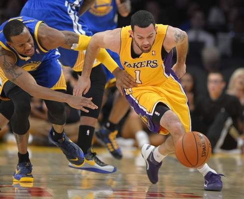Golden State Warriors forward Andre Iguodala, left, and Los Angeles Lakers guard Jordan Farmar go after a loose ball during the first half of an NBA basketball game, Friday, Nov. 22, 2013, in Los Angeles. (AP Photo/Mark J. Terrill) 