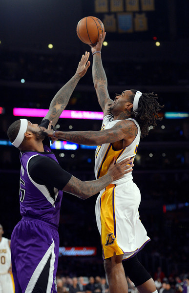 os Angeles Lakers center Jordan Hill, right, puts up a shot as Sacramento Kings center DeMarcus Cousins defends during the first half of an NBA basketball game Sunday, Nov. 24, 2013, in Los Angeles. (AP Photo/Mark J. Terrill)