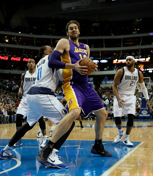 Dallas Mavericks' Shawn Marion (0) defends against a move to the basket by Los Angeles Lakers' Pau Gasol (16) of Spain as Vince Carter (25) and Monta Ellis, left rear, watch in the first half of an NBA basketball game, Tuesday, Jan. 7, 2014, in Dallas. (AP Photo/Tony Gutierrez)