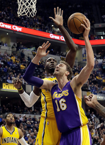 Los Angeles Lakers center Pau Gasol, of Spain, right, shoots in front of Indiana Pacers center Roy Hibbert during the first half of an NBA basketball game in Indianapolis, Tuesday, Feb. 25, 2014. (AP Photo/AJ Mast)