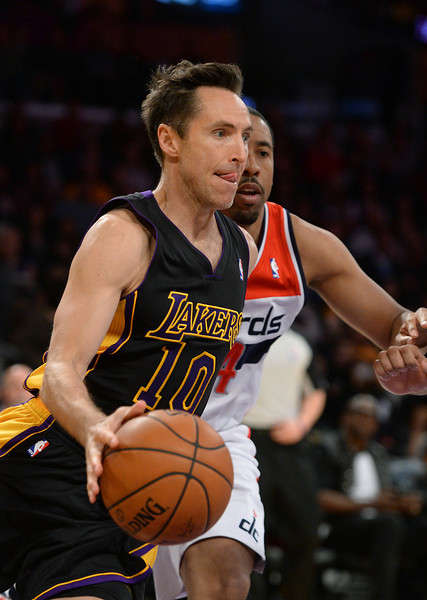 The Lakers' Steve Nash drives the baseline on the Wizards' Andre Miller, Friday, March 21, 2014, at Staples Center. (Photo by Michael Owen Baker/L.A. Daily News)