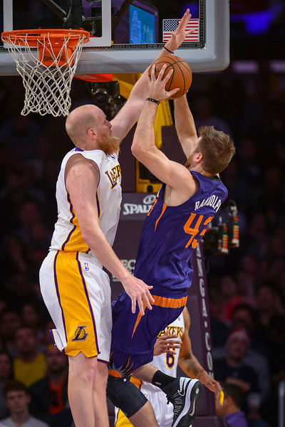 LakersÕ Chris Kaman blocks a shot by Suns Shavlik Randolph during first period action  at Staples Center Sunday, March 30, 2014.  ( Photo by David Crane/Los Angeles Daily News )