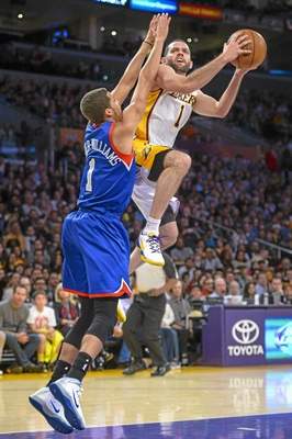 In this file photo, the Lakers´ Jordan Farmar goes up for two points as 76ers´ Michael Carter-Williams defends on the play during first half action at Staples Center on Sunday Dec. 29, 2013. (Photo by David Crane/Los Angeles Daily News file) 