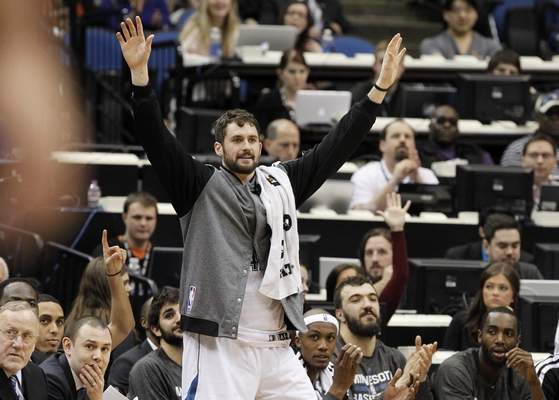 Minnesota Timberwolves forward Kevin Love cheers his teammates from the bench during the fourth quarter of an NBA basketball game against the Los Angeles Lakers in Minneapolis, Friday, March 28, 2014. The Timberwolves won 143-107. (AP Photo/Ann Heisenfelt)