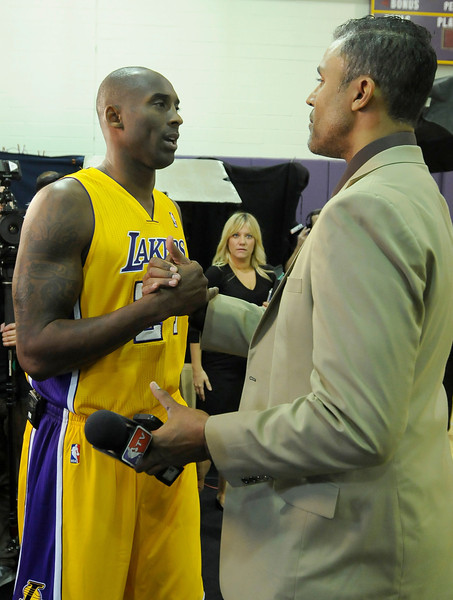 Kobe Bryant shakes hands with his old teammate and current NBA TV reporter Rick Fox. The Los Angeles Lakers held a media day at their El Segundo practice facility. Players were photographed for team materials, and interviewed by the press. El Segundo, CA. 9/27/2013. photo by (John McCoy/Los Angeles Daily News)