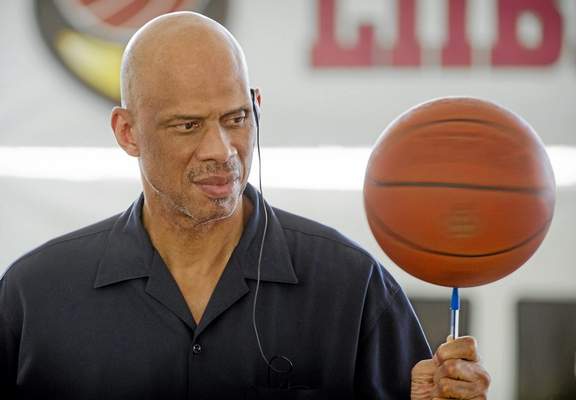 Former UCLA and Lakers great Kareem Abdul-Jabbar, spinning a basketball while visiting children last year in the Alemao complex slum in Rio de Janeiro, Brazil, is interested in joining part of a future Milwaukee Bucks ownership group. (Victor R. Caivano/The Associated Press) 