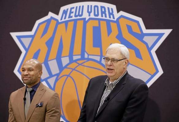 While Derek Fisher, left, listens, New York Knicks president Phil Jackson speaks during a news conference in Tarrytown, N.Y., Tuesday, June 10, 2014. The Knicks hired Fisher as their new coach on Tuesday, with Jackson turning to one of his trustiest former players. (AP Photo/Seth Wenig) 