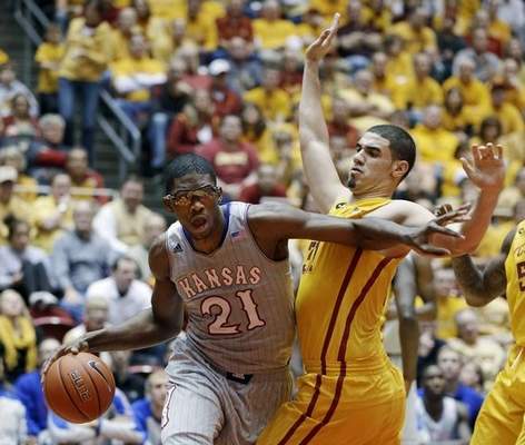 In this Jan. 13, 2014, file photo, Kansas center Joel Embiid (21) drives past Iowa State forward Georges Niang during an NCAA college basketball game in Ames, Iowa. Embiid didn't pick up a basketball until a few years ago, when a friend informed him that very few 7-footers succeed in soccer. A couple months later, Embiid was lured to a basketball camp in the Cameroon capital of Yaounde run by Timberwolves forward Luc Richard Mbah a Moute, one of just two players from Cameroon to have played in the NBA. (Charlie Neibergall/The Associated Press File) 