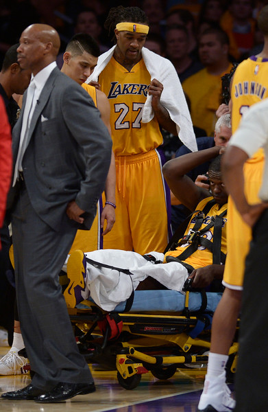 "Lakers players gathered around #30 Julius Randle after he broke his leg on a play in the 4th quarter. The Lakers played the Houston Rockets in the opening game of the 2014-2015 Season. Los Angeles, CA. 10/28/2014 (Photo by John McCoy Daily News )"
