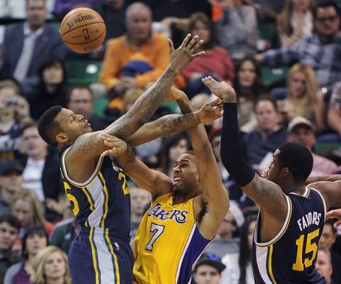 In this file photo, Utah Jazz’s Brandon Rush, left, and Derrick Favors defend as Los Angeles Lakers’ Xavier Henry (7) passes the ball during the first half of an NBA basketball game Friday, Dec. 27, 2013, in Salt Lake City. (Gene Sweeney Jr./The Associated Press file)
