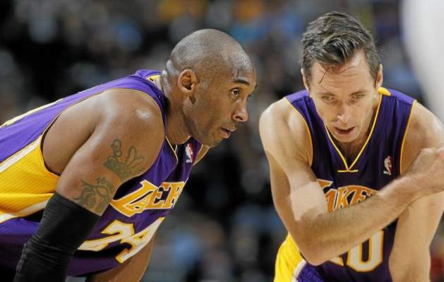 Los Angeles Lakers guards Kobe Bryant, left, and Steve Nash confer during a break in action in the fourth quarter of the Denver Nuggets' 126-114 victory over the Lakers in an NBA game in Denver on Wednesday, Dec. 26, 2012. (David Zalubowski/AP File Photo) 