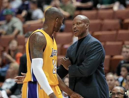 os Angeles Lakers coach Byron Scott, right, talks to Kobe Bryant during the first half of a preseason NBA basketball game against the Utah Jazz on Thursday, Oct. 16, 2014, in Anaheim, Calif. (AP Photo/Jae C. Hong) 