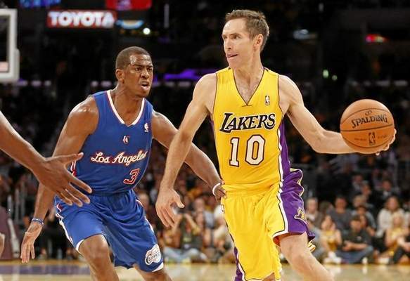 File photo: Los Angeles Lakers' Steve Nash, right, passes off the ball as Los Angeles Clippers' Chris Pauldefends during the first half of an NBA basketball game in Los Angeles, Tuesday, Oct. 29, 2013. (Danny Moloshok/The Associated Press file photo) 