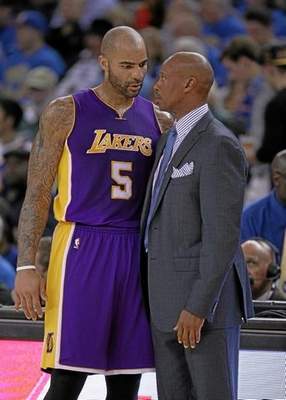 First-year Lakers coach Byron Scott, talking to Carlos Boozer, has the support of his players despite the team’s struggles at the beginning of the season. The players respect Scott’s history as a player, his honesty and his calm demeanor. (Ezra Shaw ‑ Getty Images) 