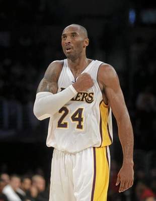 Los Angeles Lakers' Kobe Bryant reacts after making a basket against the Toronto Raptors in overtime of an NBA basketball game Sunday, Nov. 30, 2014, in Los Angeles. The Lakers won 129-122. (AP Photo/Jae C. Hong