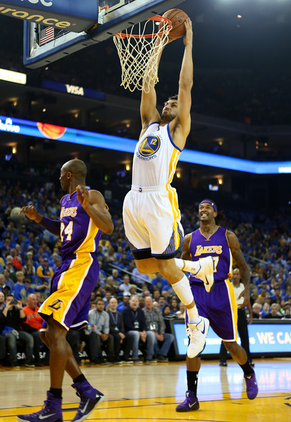"Golden State Warriors' Andrew Bogut (12) dunks the ball against Los Angeles Lakers' Kobe Bryant (24) and Jordan Hill (27) in the first quarter of their game at Oracle Arena in Oakland, Calif., Saturday, Nov. 1, 2014. (Anda Chu/Bay Area News Group) "