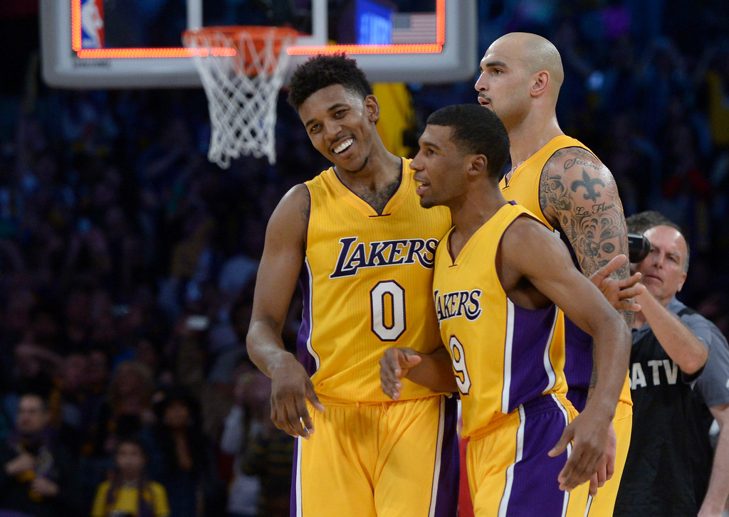 "Lakers#0 Nick Young, Ronnie Price Robert Sacre celebrate in the 4th quarter.  and The Lakers defeated the Golden State Warriors 115-105 in a game played at Staples Center in Los Angeles, CA. December 23, 2014. (Photo by John McCoy Daily News)"
