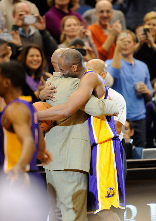 "MINNEAPOLIS, MN - DECEMBER 14: Kobe Bryant #24 of the Los Angeles Lakers hugs head coach Byron Scott after passing Michael Jordan on the all-time scoring list with a free throw in the second quarter of the game on December 14, 2014 at Target Center in Minneapolis, Minnesota. NOTE TO USER: User expressly acknowledges and agrees that, by downloading and or using this Photograph, user is consenting to the terms and conditions of the Getty Images License Agreement. (Photo by Hannah Foslien/Getty Images)"