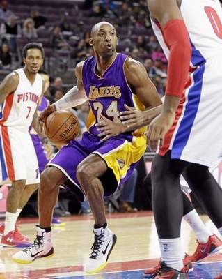 The Lakers’ Kobe Bryant, center, overcame early fatigue to score 12 points in Tuesday’s 106-96 victory over Detroit. Jordan Hill led the Lakers with 22 points. Carlos Osorio ‑ The Associated Press