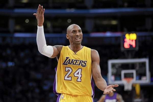 Los Angeles Lakers' Kobe Bryant gestures while arguing with a referee during the first half of an NBA basketball game against the Sacramento Kings, Tuesday, Dec. 9, 2014, in Los Angeles. (AP Photo/Jae C. Hong) 