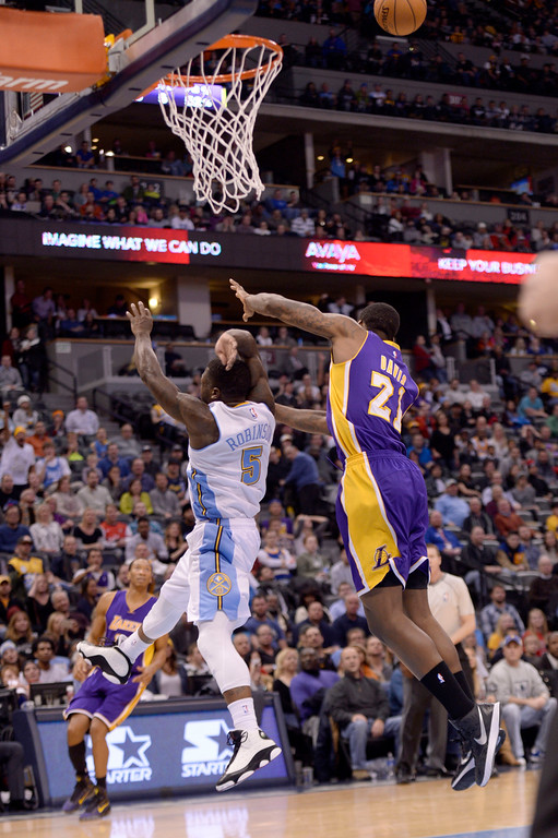 "DENVER, CO - DECEMBER 30: Nate Robinson (5) of the Denver Nuggets fouls Ed Davis (21) of the Los Angeles Lakers on a play that would lead to Robinson's second technical and eventual ejection during the second half of the Lakers' 111-103 win. The Denver Nuggets hosted the Los Angeles Lakers at the Pepsi Center on Monday, December 30, 2014. (Photo by AAron Ontiveroz/The Denver Post)"