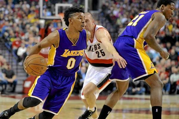 Portland Trail Blazers' Steve Blake (25) defends against Los Angeles Lakers' Nick Young (0) during the first half of an NBA basketball game in Portland, Ore., Wednesday Feb. 11, 2015. (AP Photo/Greg Wahl-Stephens)  