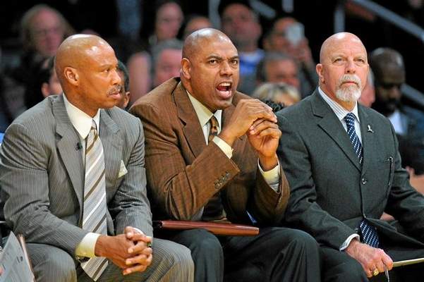 Lakers assistant coach Paul Pressey, center, sitting between head coach Byron Scott, left, and trainer Gary Vitti, has used his years of playing and coaching in the NBA to help the Lakers get through this difficult season. (Michael Owen Baker/Staff Photographer) 