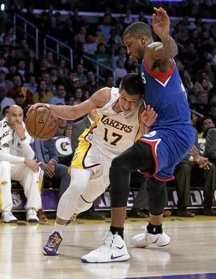 Philadelphia 76ers' Thomas Robinson, right, pressures Los Angeles Lakers' Jeremy Lin during the second half of an NBA basketball game, Sunday, March 22, 2015, in Los Angeles. The Lakers 101-87. (AP Photo/Jae C. Hong) 