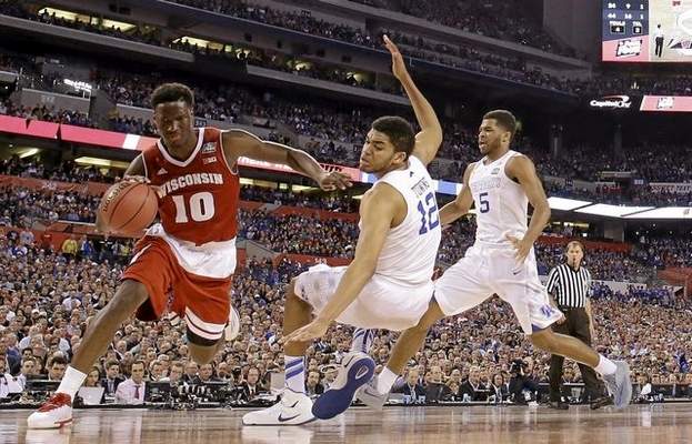 Wisconsin's Nigel Hayes (10) drives against Kentucky's Karl-Anthony Towns (12) during the second half of the NCAA Final Four tournament college basketball semifinal game Saturday, April 4, 2015, in Indianapolis. (AP Photo/Michael Conroy) 
