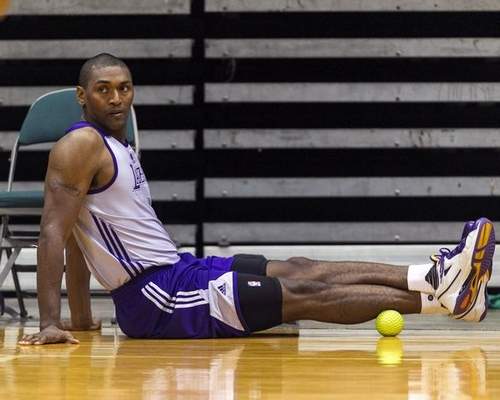 Metta World Peace stretches off the court during Lakers practice in Honolulu. (AP Photo/Marco Garcia) 