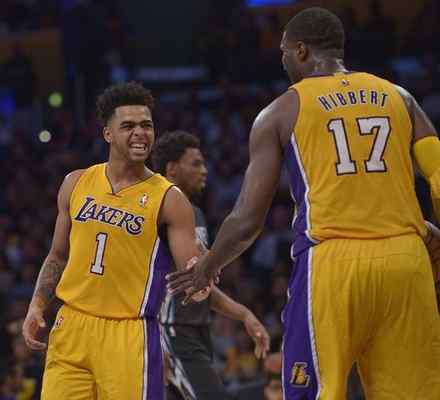 Lakers rookie D’Angelo Russell, seen celebrating Thursday with center Roy Hibbert, is moving back to point guard after playing the opener at shooting guard. (John McCoy/Staff Photographer) 
