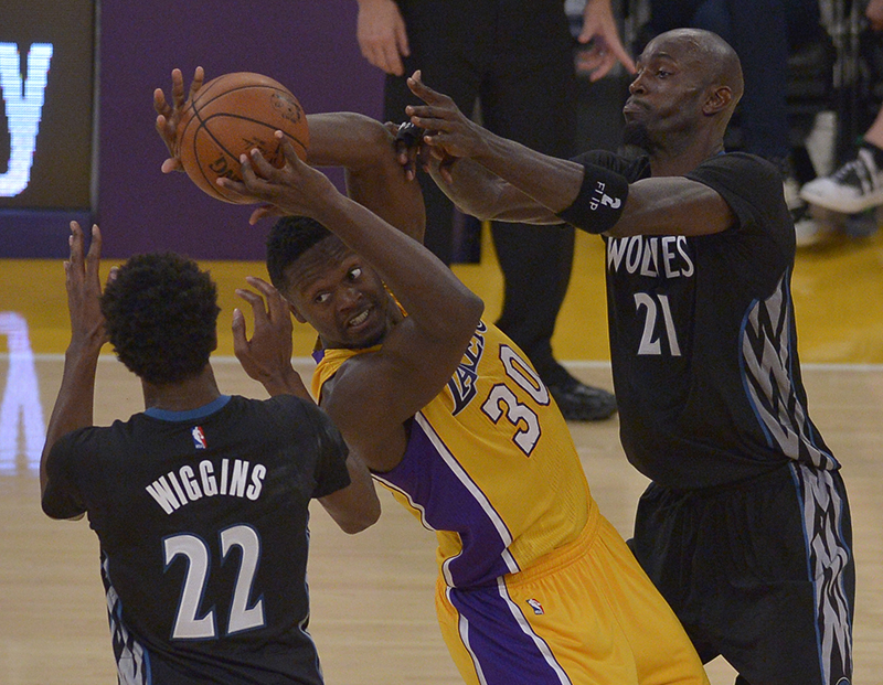 Los Angeles Lakers forward Julius Randle #30 gets tied up by Minnesota Timberwolves forward Andrew Wiggins #22 and Minnesota Timberwolves forward Kevin Garnett #21 in the second quarter. The Lakers played the Minnesota Timberwolves in the opening game of the 2015-16 NBA season. Los Angeles, CA, 10/28/2015 (photo by John McCoy/Los Angeles News Group)