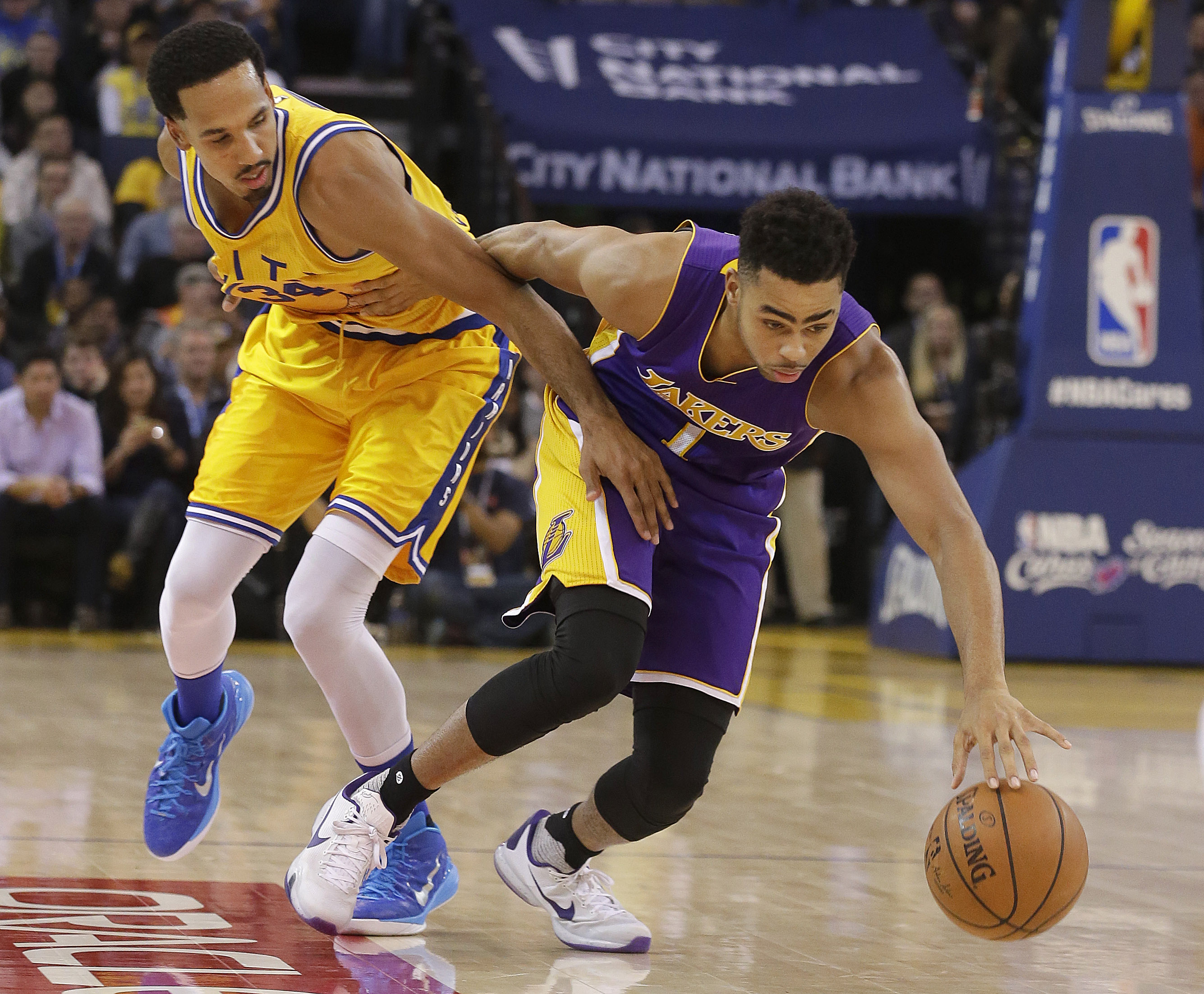 Los Angeles Lakers guard D'Angelo Russell (1) dribbles past Golden State Warriors guard Shaun Livingston during the first half of an NBA basketball game in Oakland, Calif., Tuesday, Nov. 24, 2015. (AP Photo/Jeff Chiu)