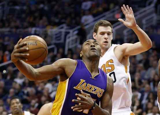 Metta World Peace, left, gets fouled Monday as Phoenix Suns' Jon Leuer, right, defends. (AP Photo/Ross D. Franklin) 