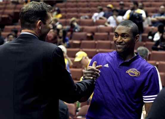 Lakers forward Metta World Peace, right, greets Golden State Warriors interim head coach Luke Walton before preseason game in Anaheim. AP Photo/Alex Gallardo