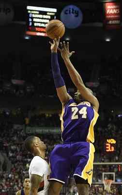 Los Angeles Lakers forward Kobe Bryant (24) reaches in on Portland Trail Blazers center Mason Plumlee (24) during the first half of an NBA basketball game in Portland, Ore., Saturday, Jan. 23, 2016. (AP Photo/Steve Dykes) 