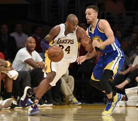 The Lakers' Kobe Bryant, left, drives while being guarded by Golden State's Stephen Curry during Sunday's game at Staples Center. (AP Photo/Kelvin Kuo) 