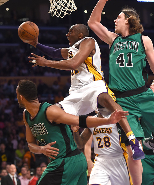 The Los Angeles Laker Kobe Bryant ,24, takes a shot  past Boston Celtic Evan Turner,11, and Kelly Olynyk ,41, past  during the 3rd quarter at the Staples Center.  Lakers lost 100-107.   Los Angeles Calif., Sunday, April ,3, 2016.           (Photo by Stephen Carr / Daily Breeze)