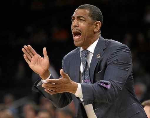 In this March 28, 2014 file photo, Connecticut coach Kevin Ollie shouts instructions during the first half in a regional semifinal against Iowa State in the NCAA men's college basketball tournament in New York.  (AP Photo/Frank Franklin II, File) 