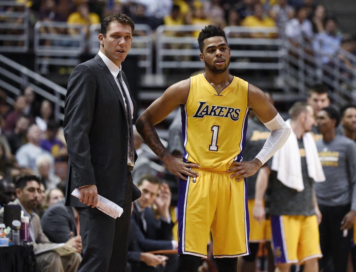 Los Angeles Lakers coach Luke Walton, left, talks with guard D'Angelo Russell during the second half of the team's NBA preseason basketball game against the Phoenix Suns in Anaheim, Calif., Friday, Oct. 21, 2016. (AP Photo/Kelvin Kuo)