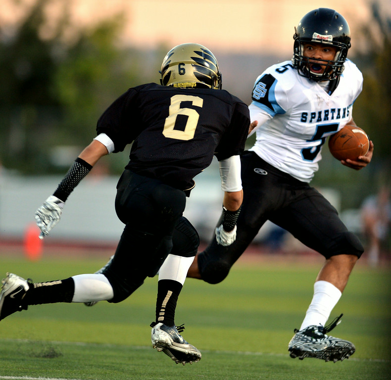 "San Gorgonio High School's quarterback Nate Meadors, right, makes a run as Citrus Valley High School's Ben LeMay gives chase during a game on Friday, August 29, 2014 at Citrus Valley High School in Redlands, Ca. (Micah Escamilla/Redlands Daily Facts)    "