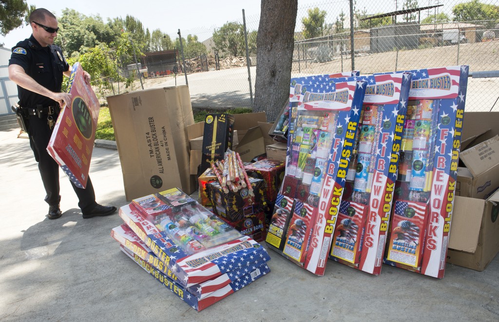 Whittier Police Officer Mike Roy catalogs illegal fireworks that were seized during an AB 109 Task force compliance check in unincorporated Whittier on Thursday June 18, 2015. There is an estimated 350-pounds of illegal fireworks that are valued at around $5,000. (Photo by Keith Durflinger/Whittier Daily News)